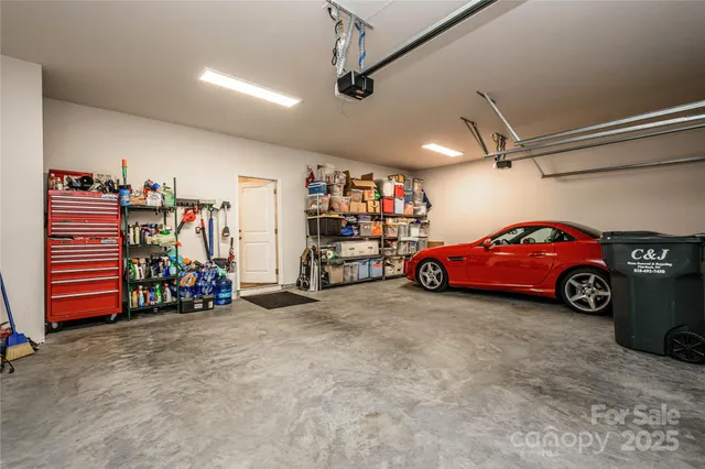 a view of a garage with a flat screen tv and a ceiling fan