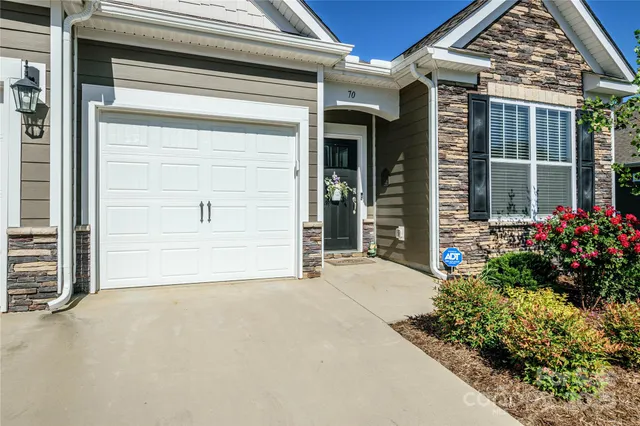 a view of a street with potted plants