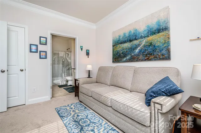 a living room with furniture and a painting on the wall