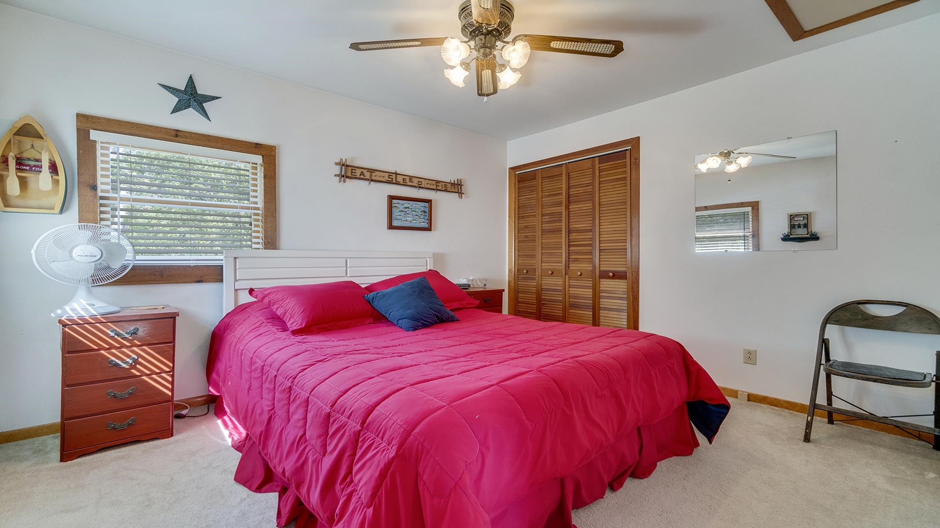 2859 South Brooks Island Road Oregon, IL 61061 - Photo 22 of 39 a bedroom with a bed a chandelier and a dresser