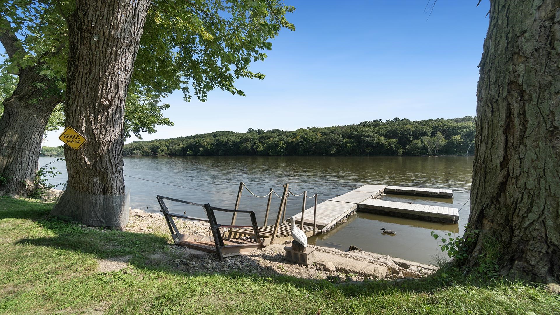 2859 South Brooks Island Road Oregon, IL 61061 - Photo 26 of 39 a view of a lake with a yard and a large tree