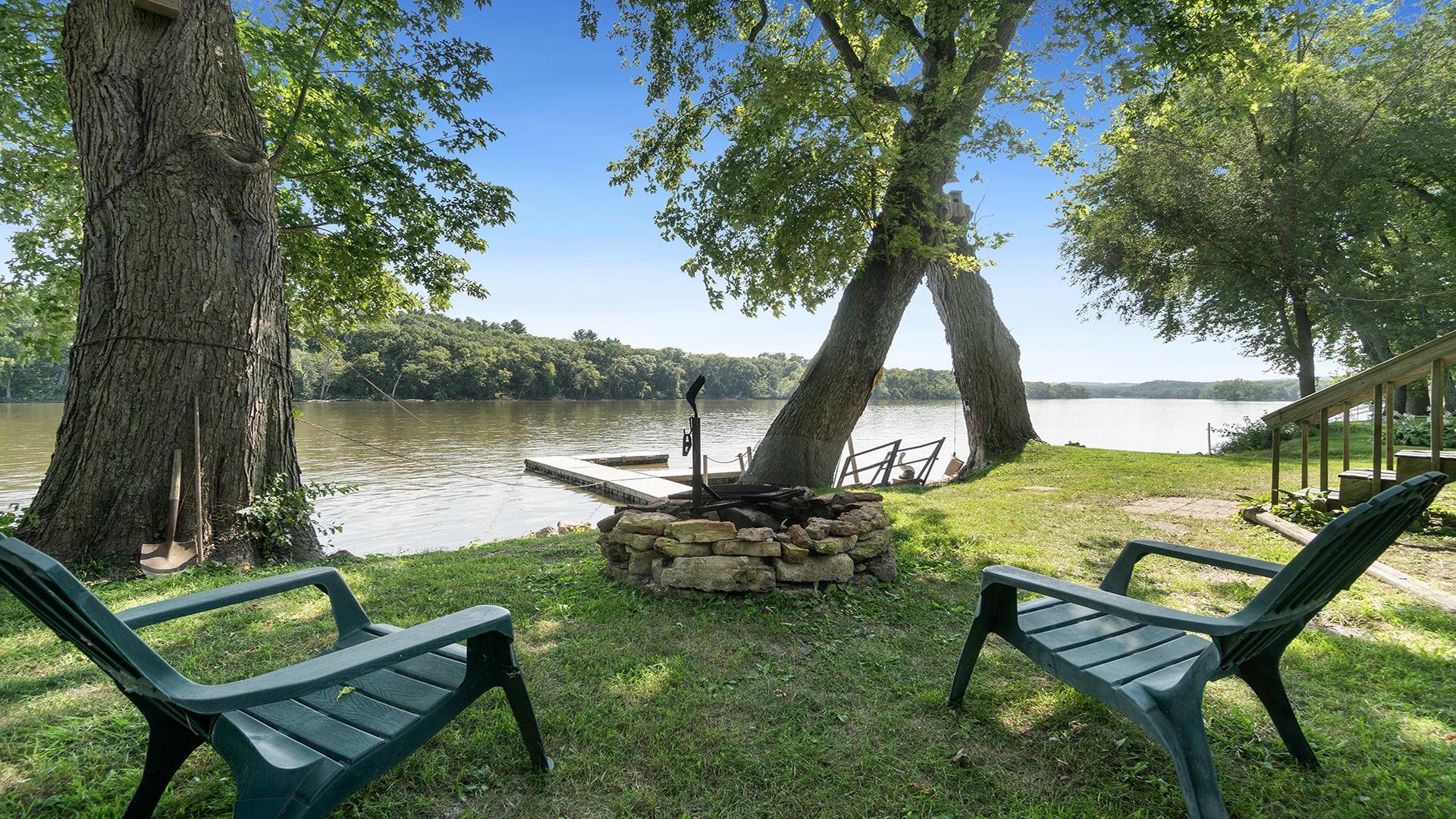 2859 South Brooks Island Road Oregon, IL 61061 - Photo 27 of 39 a view of a lake with couches and wooden fence