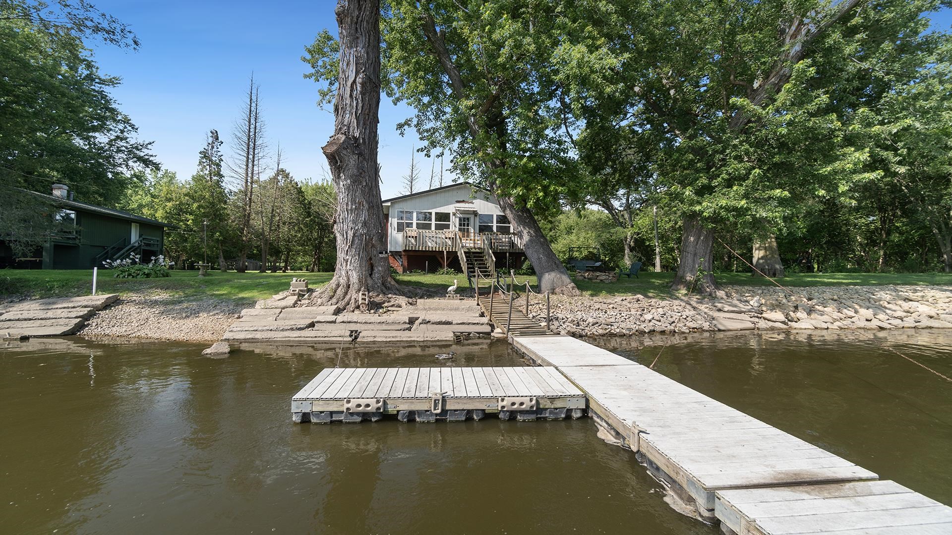 2859 South Brooks Island Road Oregon, IL 61061 - Photo 30 of 39 a view of a lake with couches and wooden fence