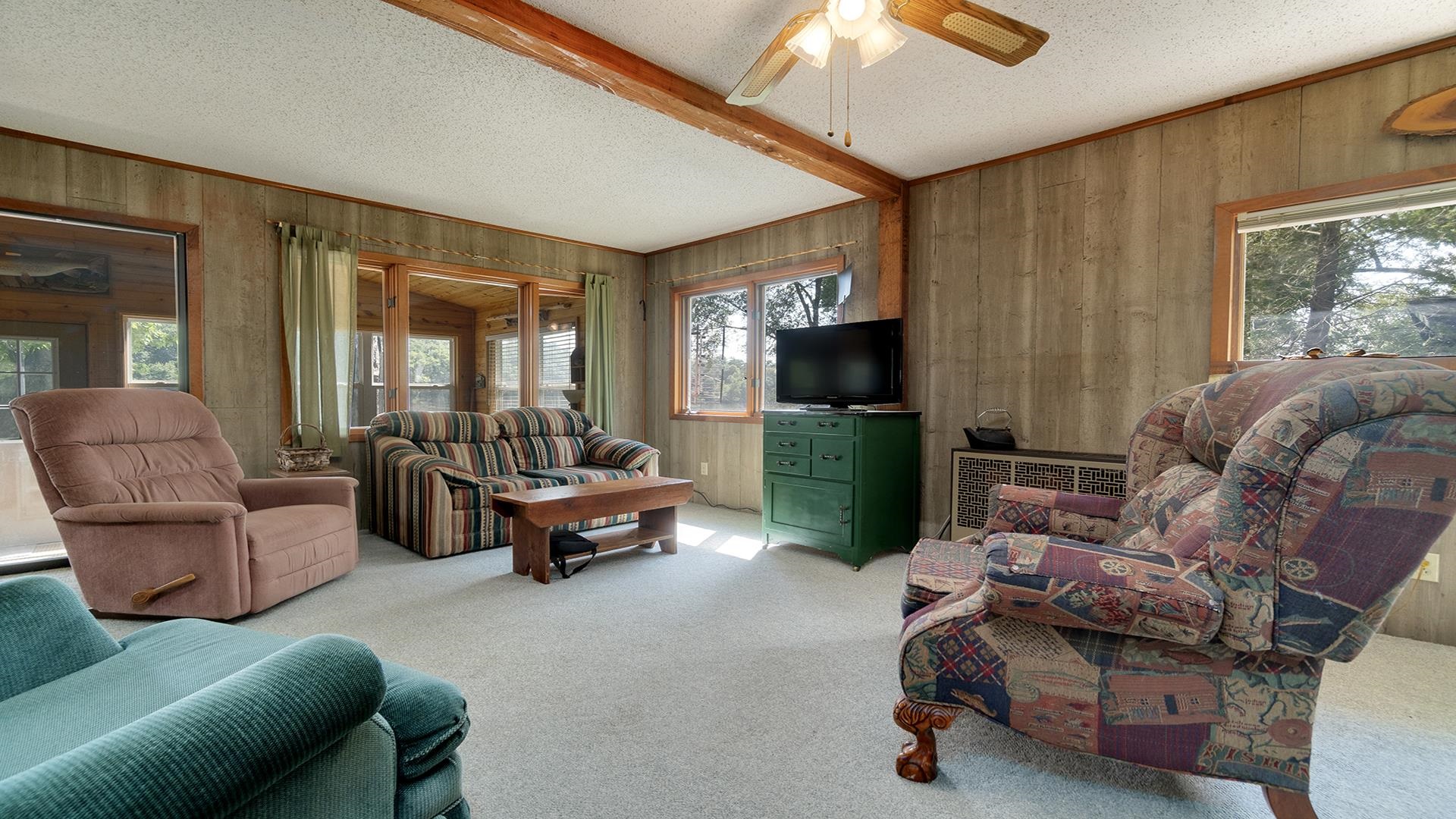 2859 South Brooks Island Road Oregon, IL 61061 - Photo 5 of 39 a living room with furniture and a flat screen tv