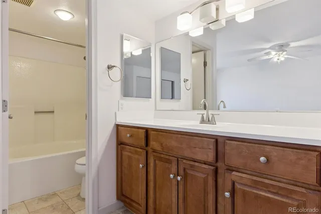 a bathroom with a tub a sink and a mirror
