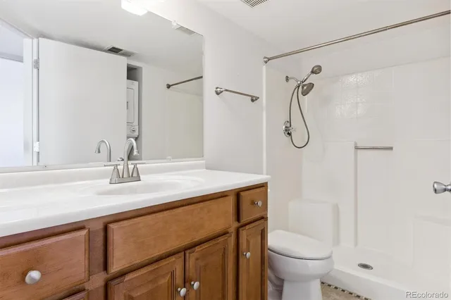 a bathroom with a sink toilet vanity and shower