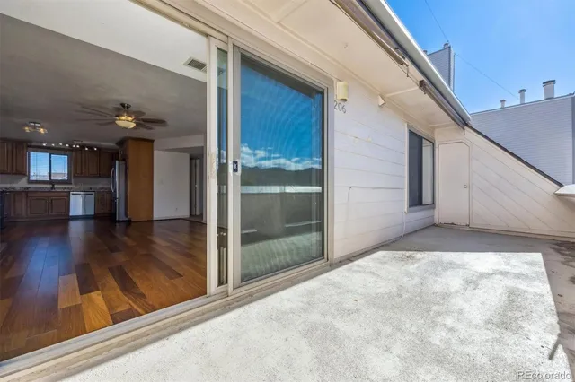 a view of a hallway with wooden floor and a living room