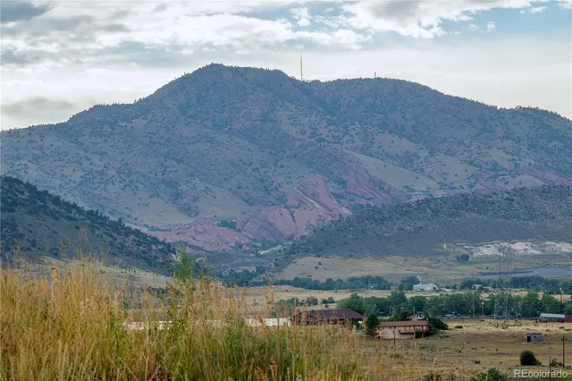 an aerial view of a house with a yard and lake view