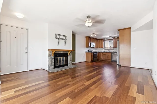 a view of a kitchen with a sink cabinets and wooden floor