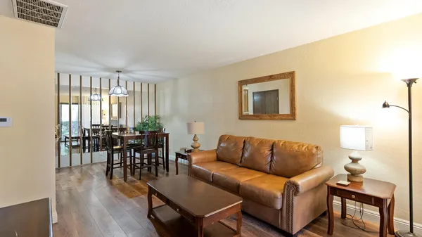 a living room with furniture a wooden floor and a window