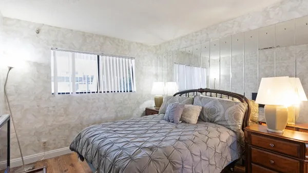 a bedroom with a bed and a lamp