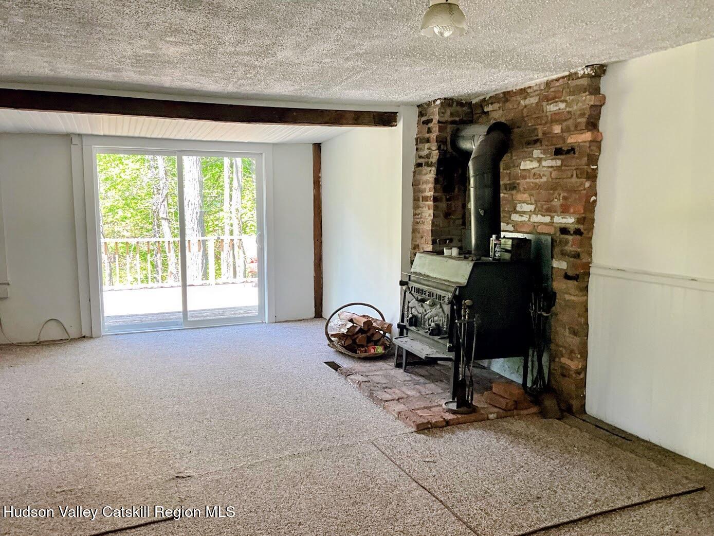 707 Springtown Road Tillson, NY 12486 - Photo 12 of 46 a room with gym equipment and a window