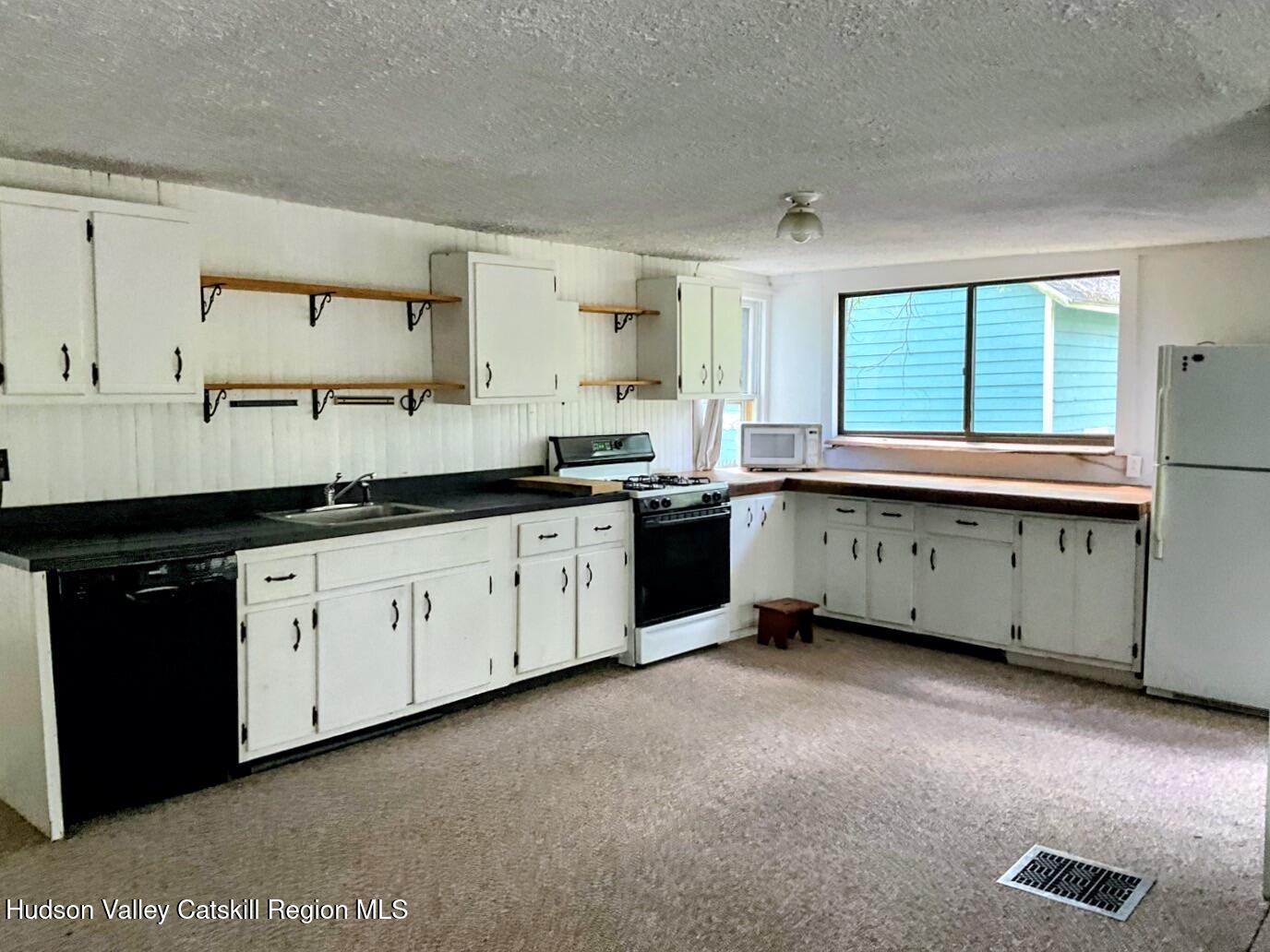 707 Springtown Road Tillson, NY 12486 - Photo 13 of 46 a kitchen with a sink stove and cabinets