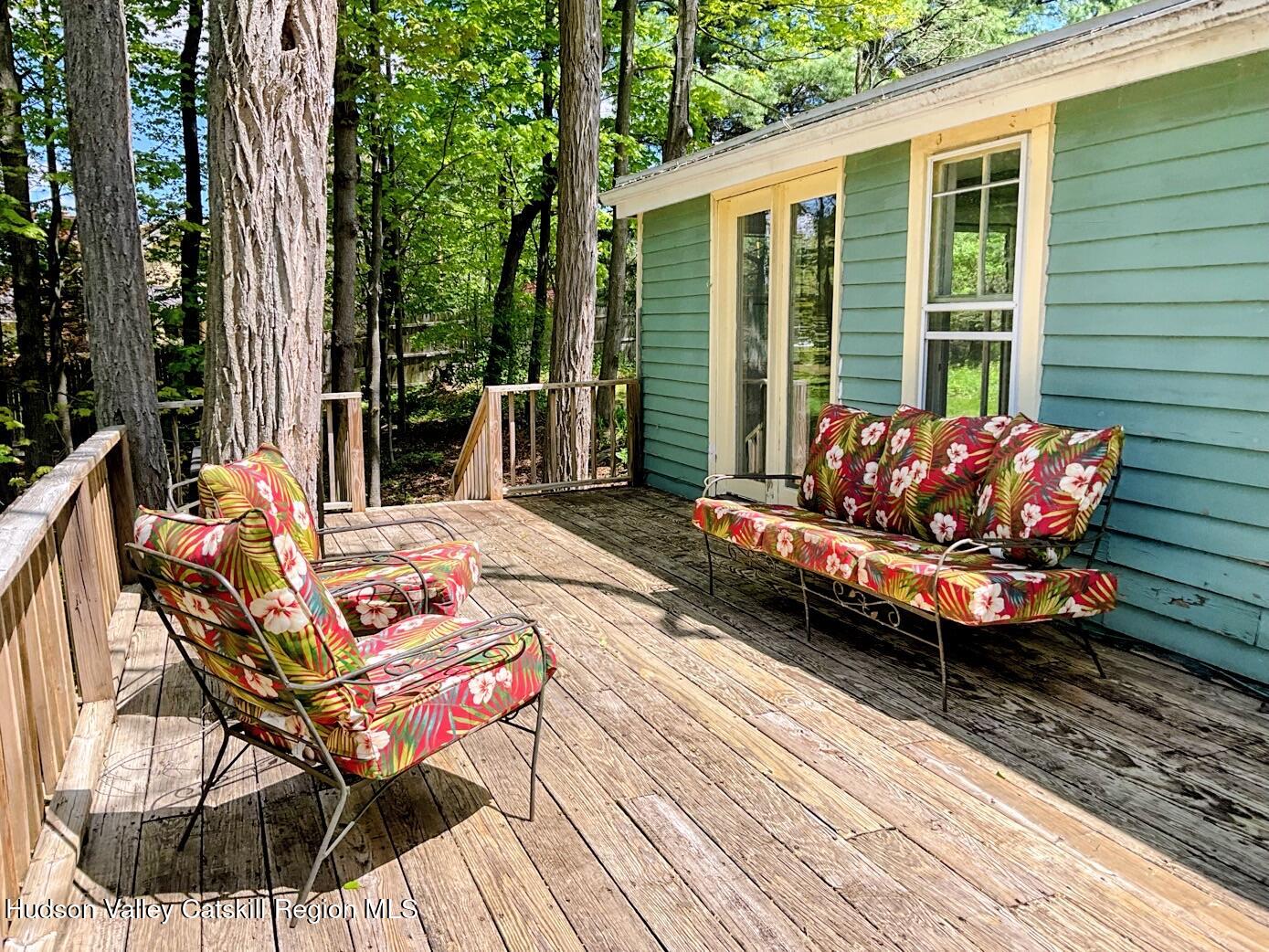 707 Springtown Road Tillson, NY 12486 - Photo 19 of 46 a roof deck with couch and wooden fence