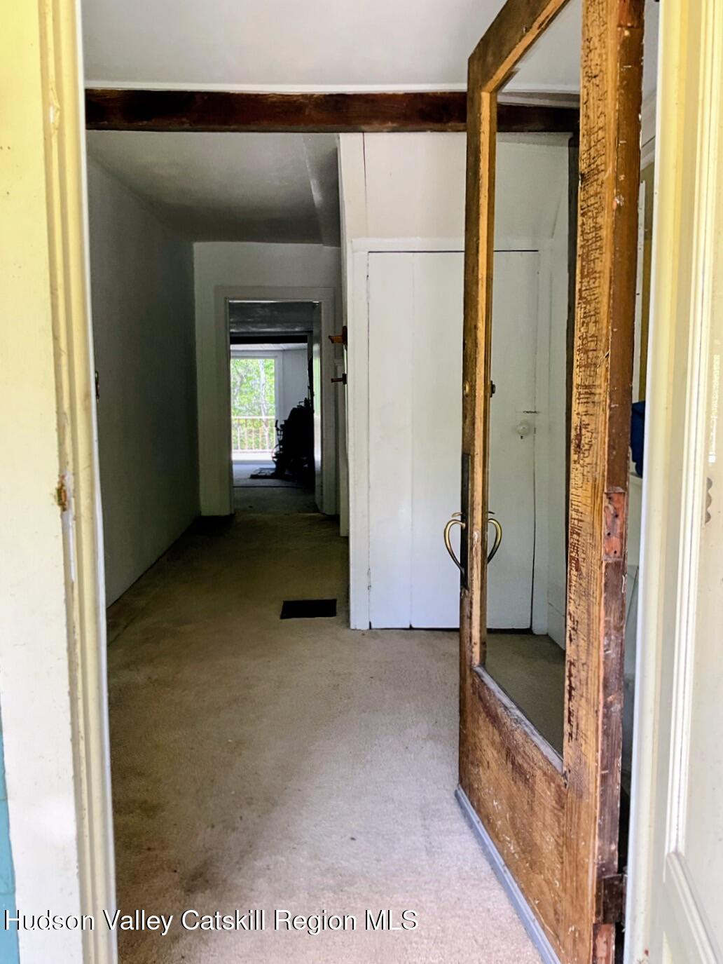 707 Springtown Road Tillson, NY 12486 - Photo 3 of 46 a view of a hallway with wooden floor and a living room