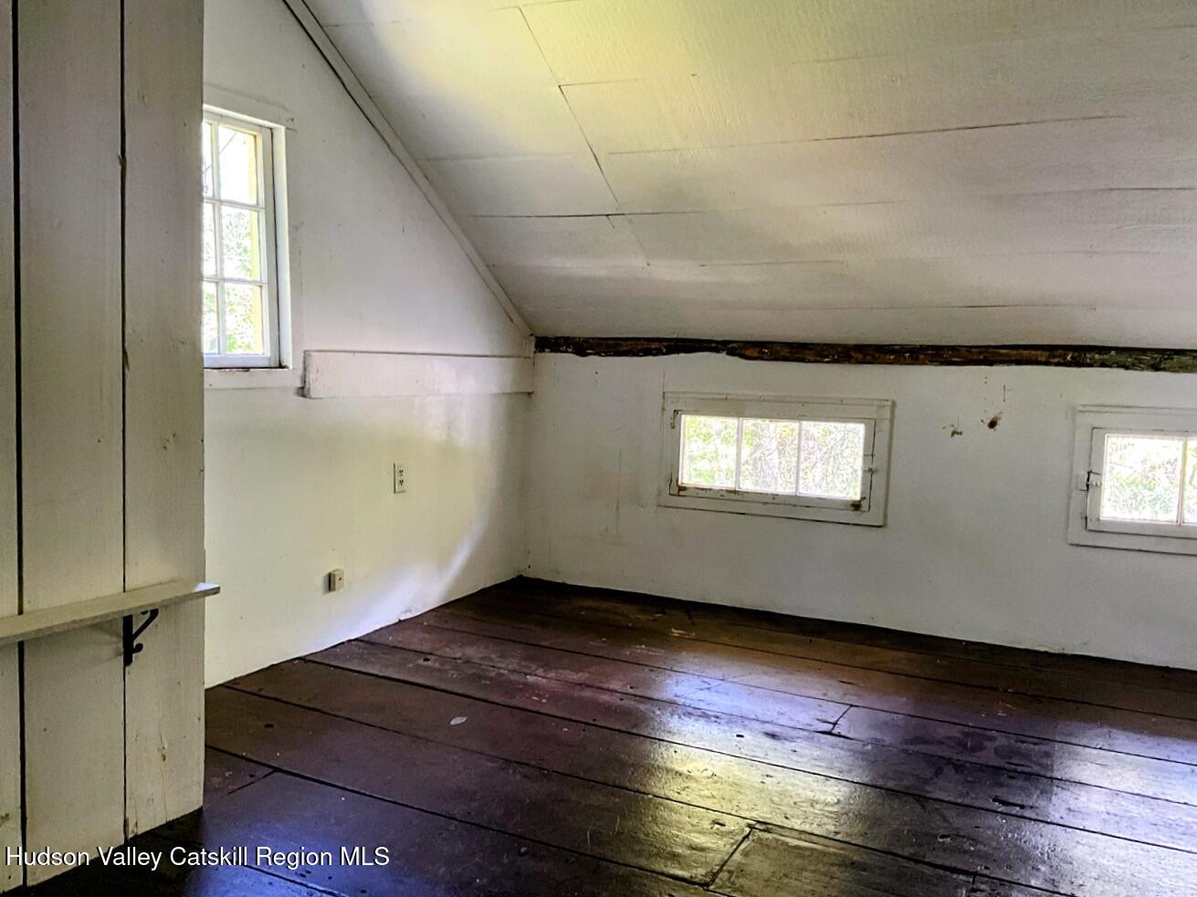 707 Springtown Road Tillson, NY 12486 - Photo 36 of 46 an empty room with wooden floor and windows