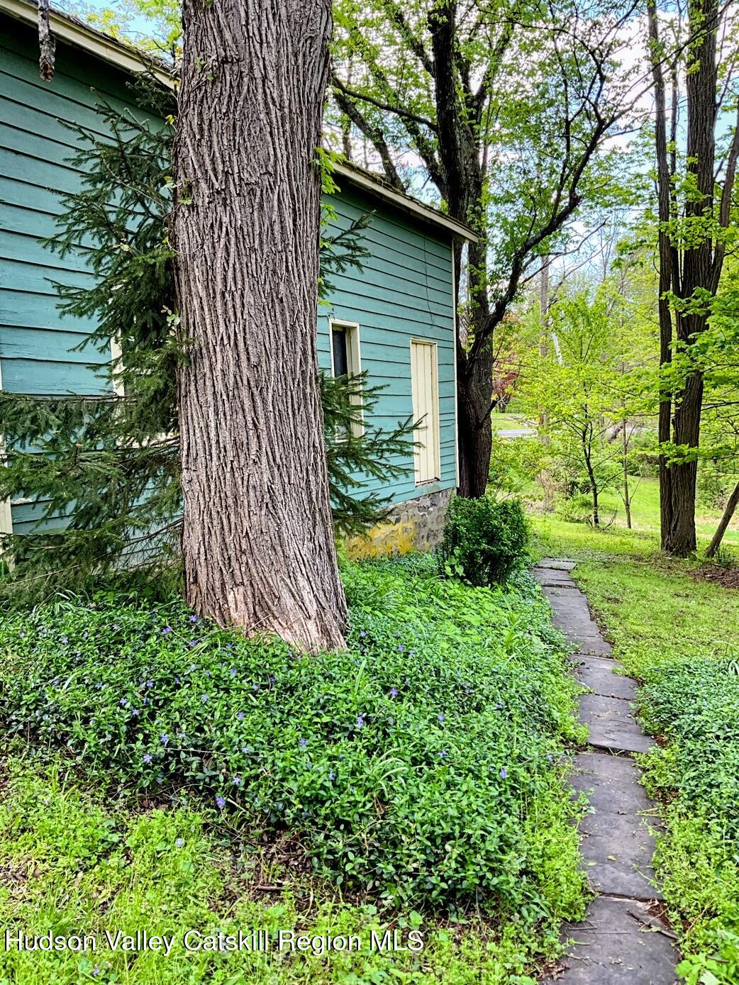 707 Springtown Road Tillson, NY 12486 - Photo 41 of 46 a view of a backyard with potted plants and large tree