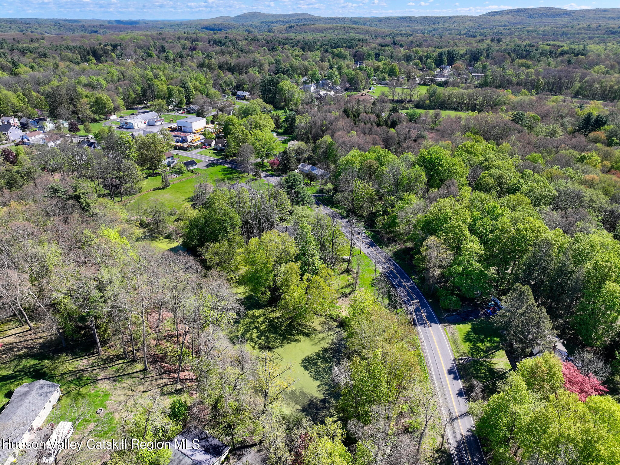 707 Springtown Road Tillson, NY 12486 - Photo 45 of 46 an aerial view of green landscape with trees houses and mountain view