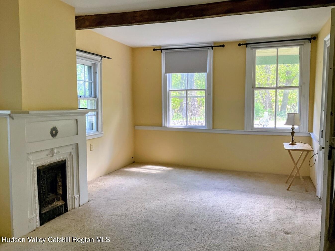 707 Springtown Road Tillson, NY 12486 - Photo 10 of 46 a view of an empty room with a fireplace and a window