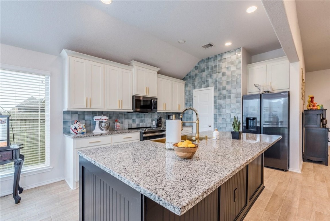 a kitchen with granite countertop counter space cabinets and stainless steel appliances