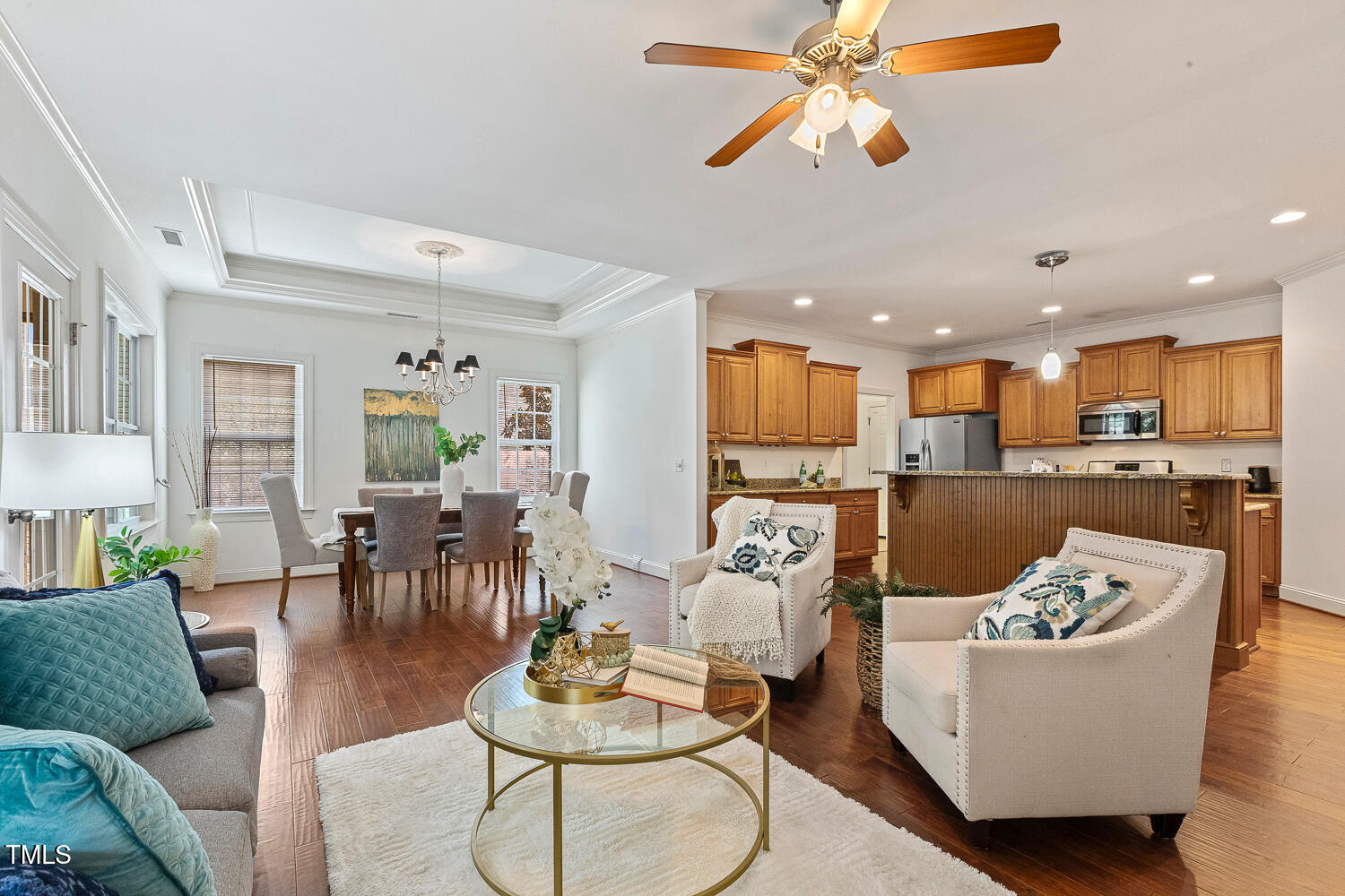 1313 Barnford Mill Road Wake Forest, NC 27587 - Photo 20 of 49 a living room with furniture kitchen view and a chandelier