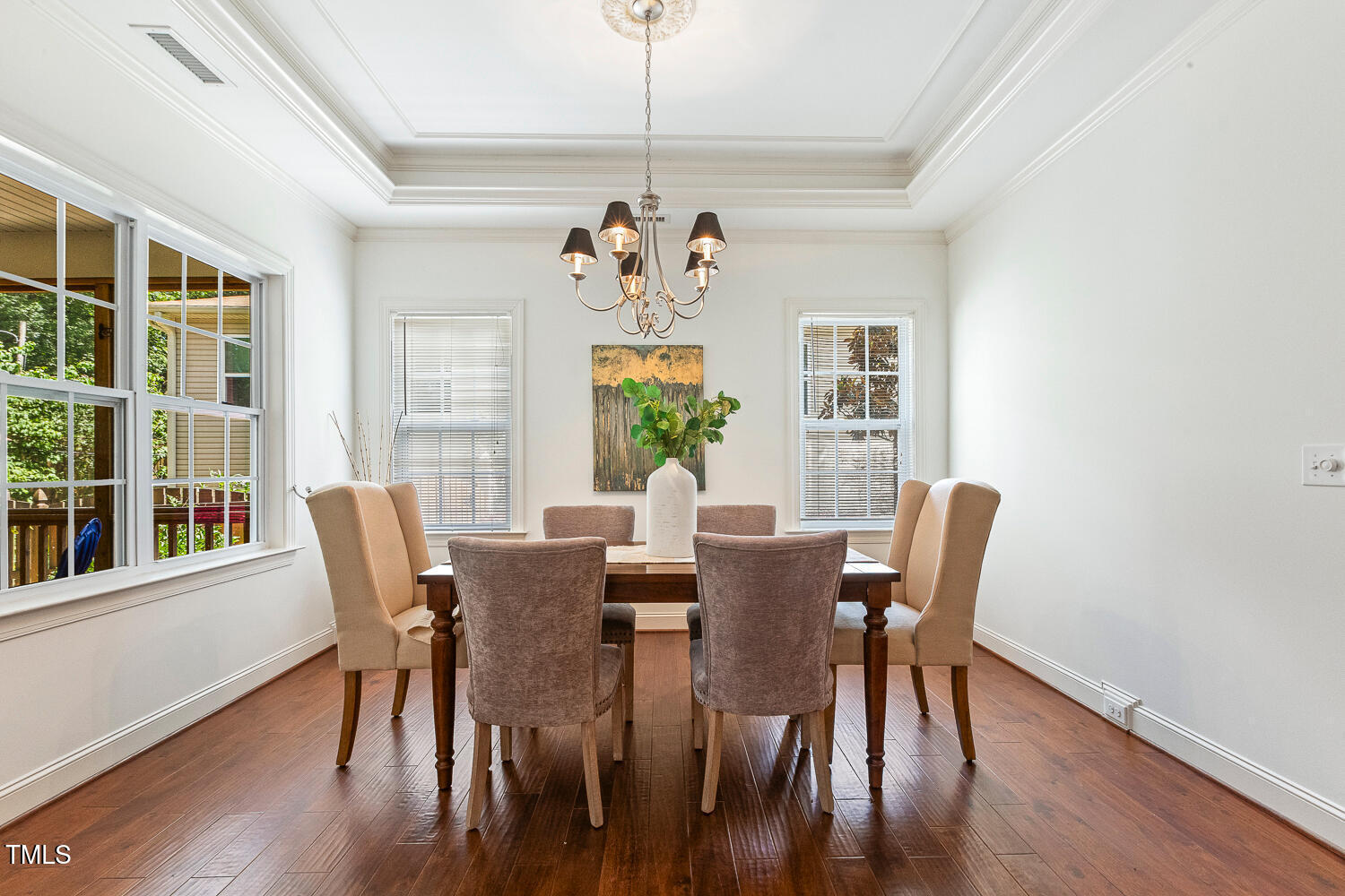 1313 Barnford Mill Road Wake Forest, NC 27587 - Photo 21 of 49 a view of a dining room with furniture a chandelier and wooden floor