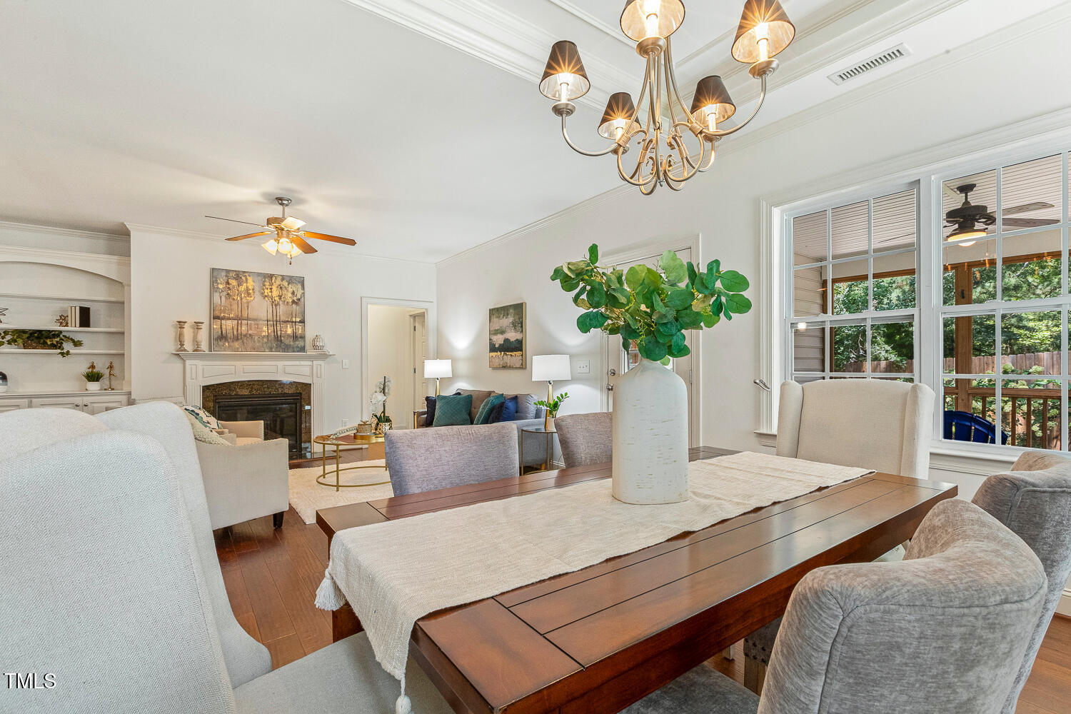 1313 Barnford Mill Road Wake Forest, NC 27587 - Photo 23 of 49 a living room with furniture a chandelier and a fireplace