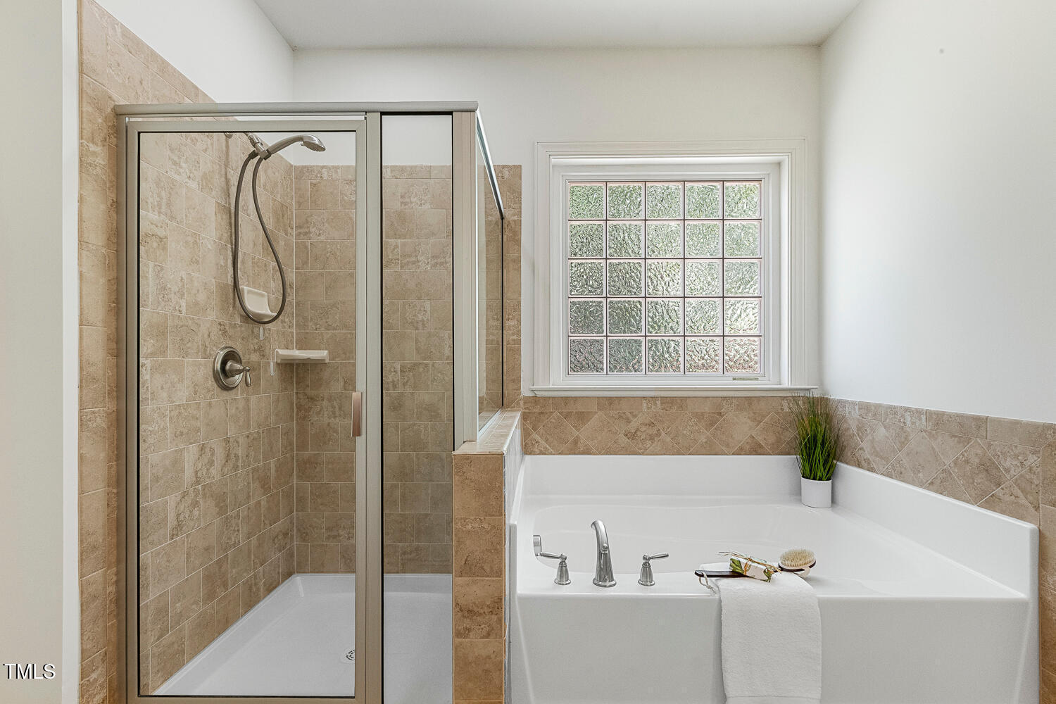 1313 Barnford Mill Road Wake Forest, NC 27587 - Photo 31 of 49 a bathroom with a bathtub and a shower