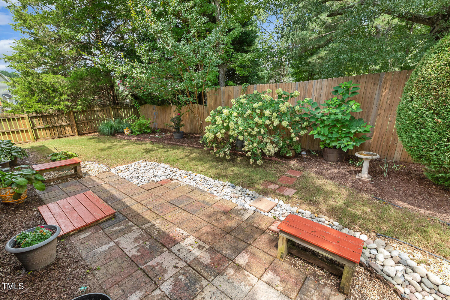 1313 Barnford Mill Road Wake Forest, NC 27587 - Photo 45 of 49 a backyard of a house with lots of green space and a fountain