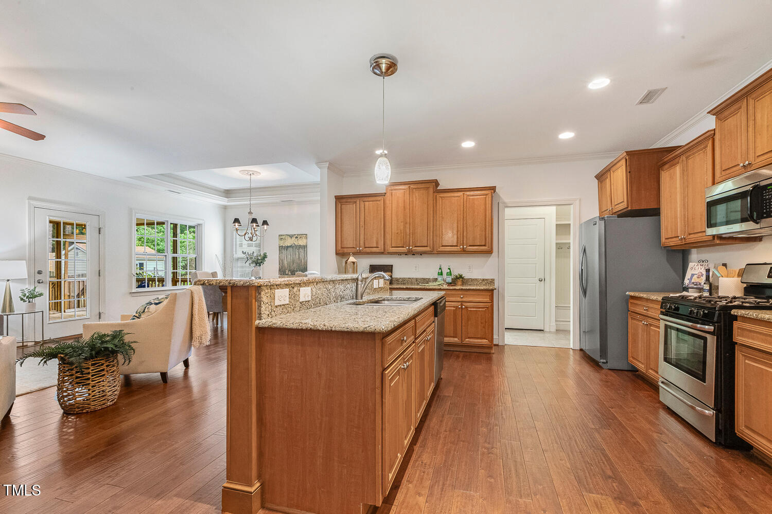 1313 Barnford Mill Road Wake Forest, NC 27587 - Photo 9 of 49 a kitchen with kitchen island granite countertop a sink a counter top space stainless steel appliances and cabinets