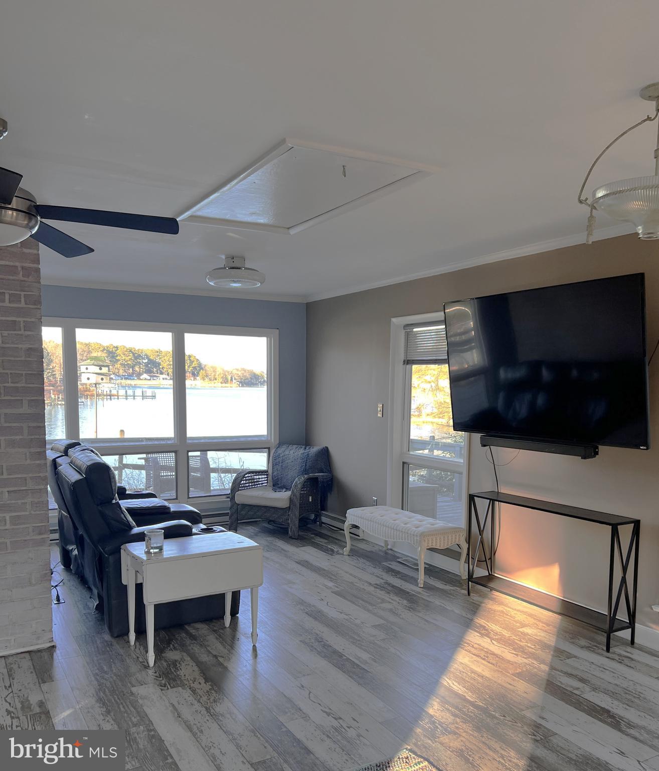 152 Swann Court Reedville, VA 22539 - Photo 11 of 33 a living room with furniture a flat screen tv and a window