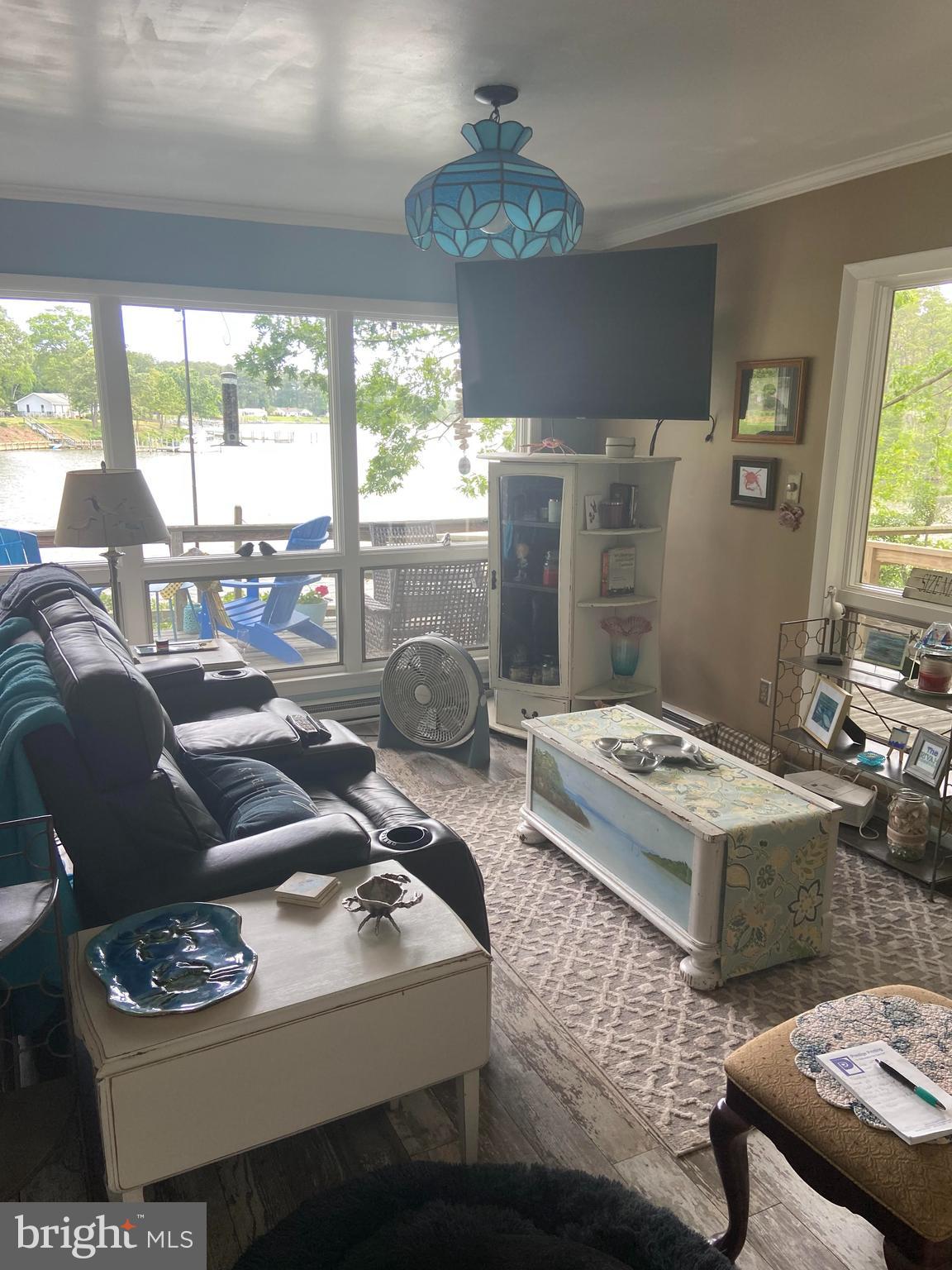 152 Swann Court Reedville, VA 22539 - Photo 17 of 33 a living room with furniture and a chandelier