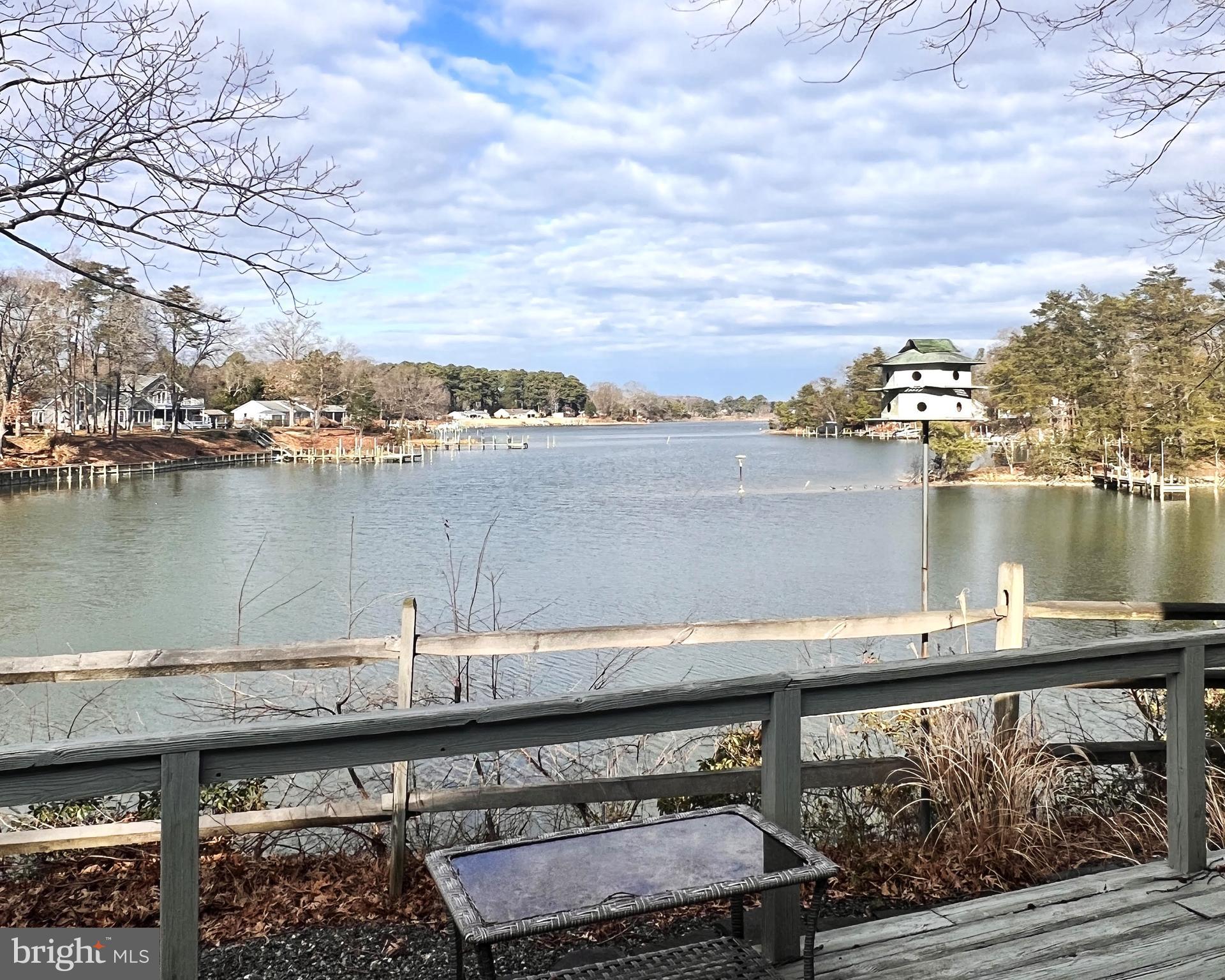 152 Swann Court Reedville, VA 22539 - Photo 2 of 33 a view of a lake with a table and chairs