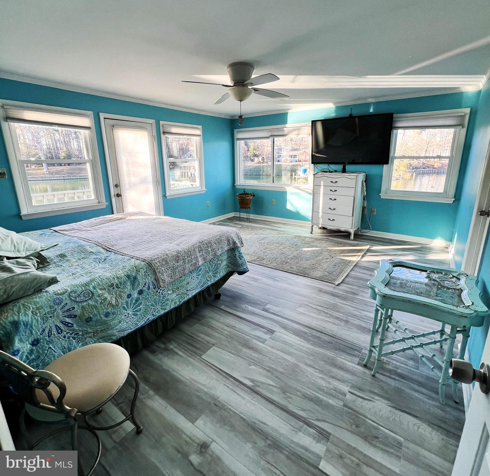 152 Swann Court Reedville, VA 22539 - Photo 21 of 33 a bedroom with a bed and a flat screen tv