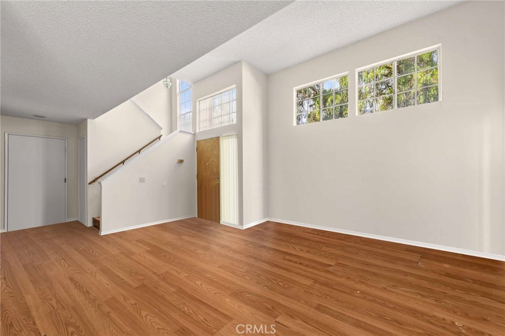 4142 Ocaso Way Oceanside, CA 92056 - Photo 7 of 16 a view of an empty room with wooden floor and a window