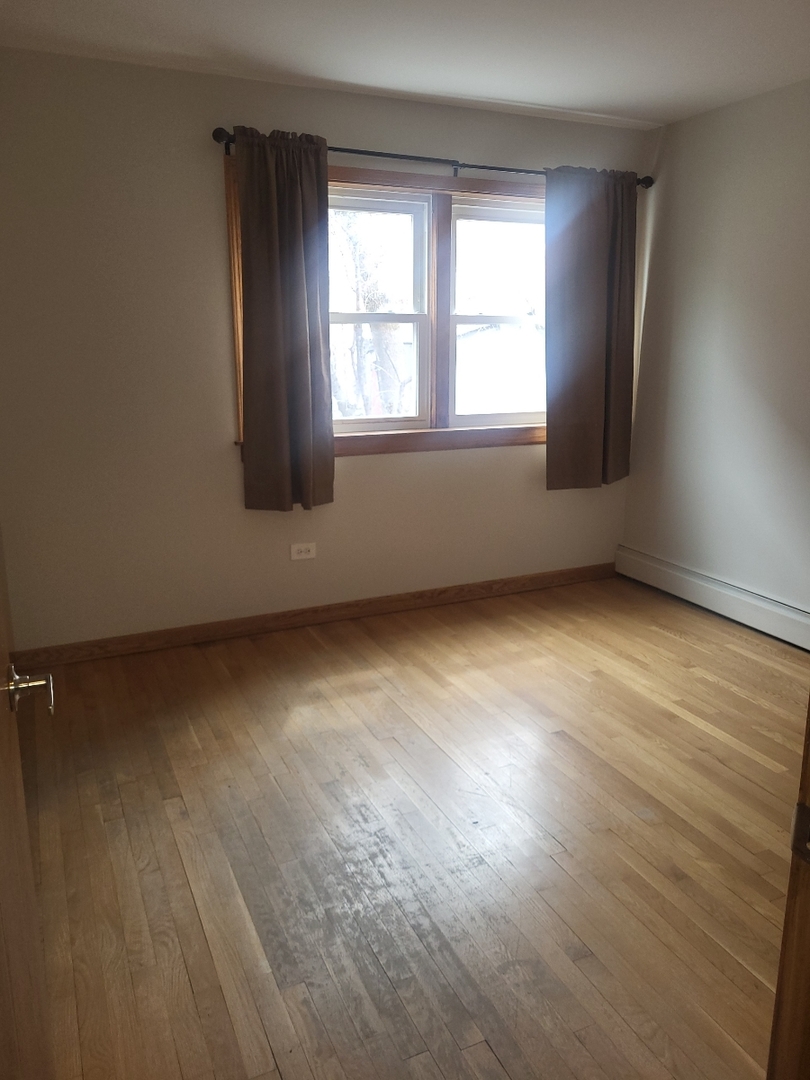 50 West Avenue, Unit 1S Riverside, IL 60546 - Photo 6 of 20 an empty room with wooden floor and windows