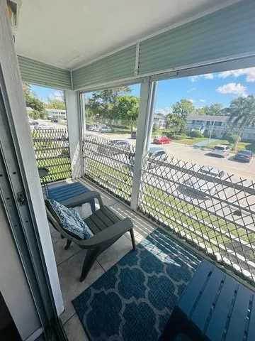 a view of a room with porch and wooden floor