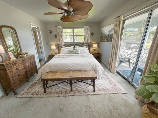 a living room with a bed furniture and a large window