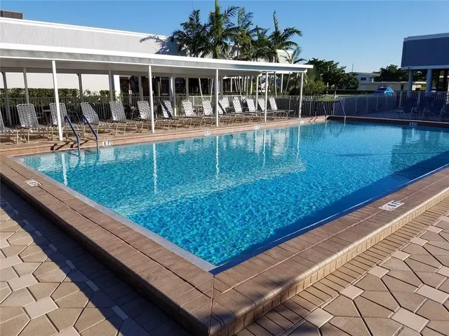 swimming pool view with a seating space
