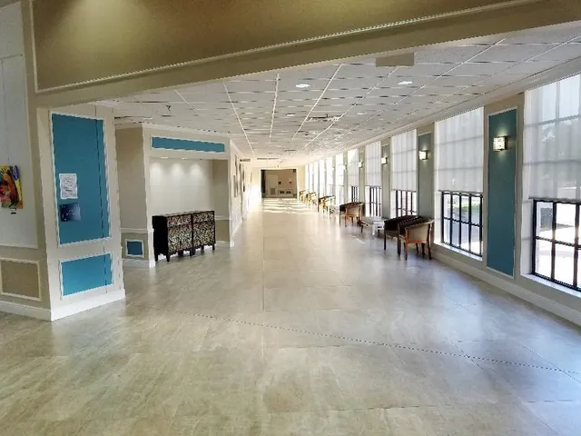 a view of dining room with furniture and floor to ceiling window