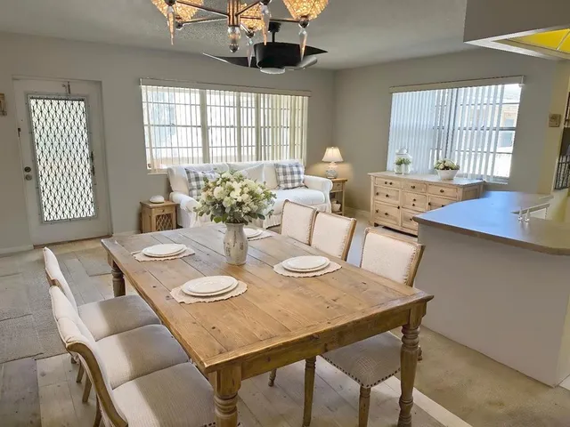 a view of a dining room with furniture and window