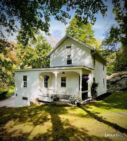 an aerial view of a house with swimming pool and porch