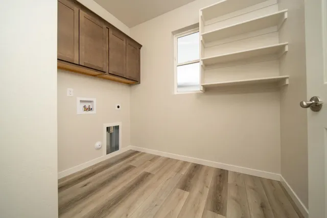 a view of a kitchen with wooden floor and cabinets