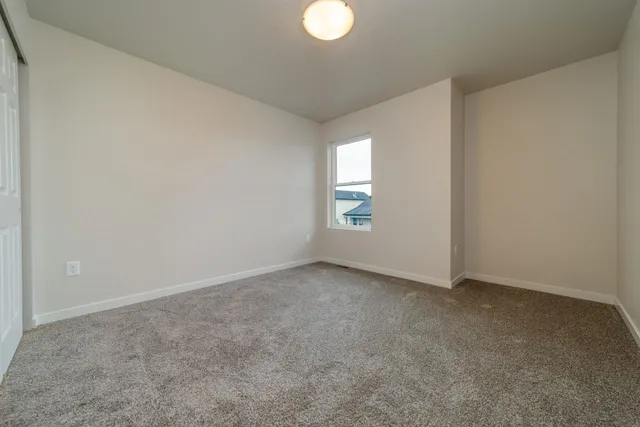 an empty room with windows and closet