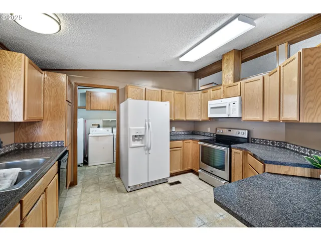 a kitchen with a refrigerator a sink and a stove