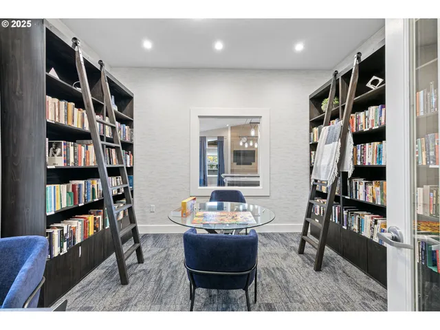 a living room with a book shelf and a wooden floor
