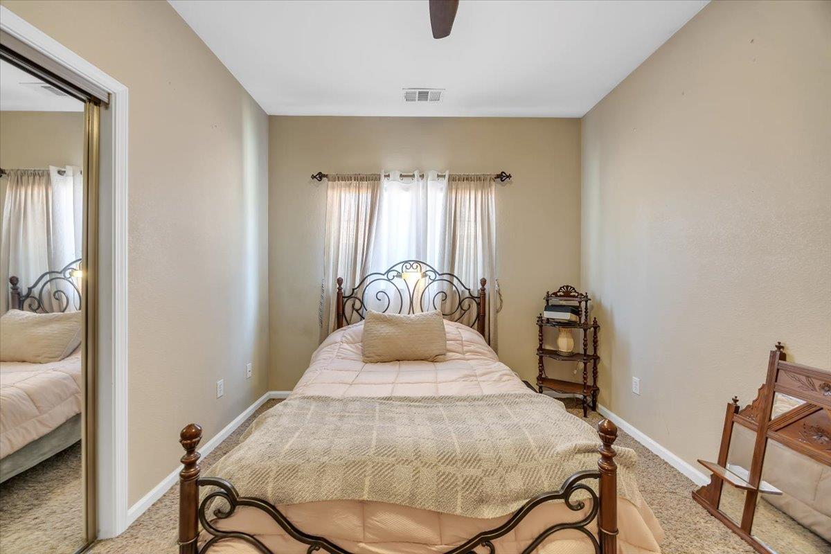 411 Sunrise Road Copperopolis, CA 95228 - Photo 43 of 76 Guest bedroom # 2 at the end of the hall features a step-in closet and backyard patio views.