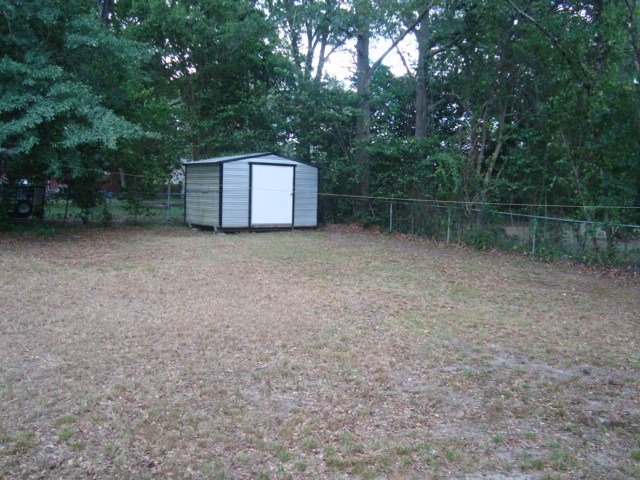 6228 Potomac Circle Columbus, GA 31909 - Photo 15 of 16 a backyard of a house with lots of green space and trampoline