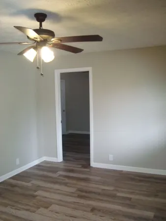 a view of an empty room and wooden floor