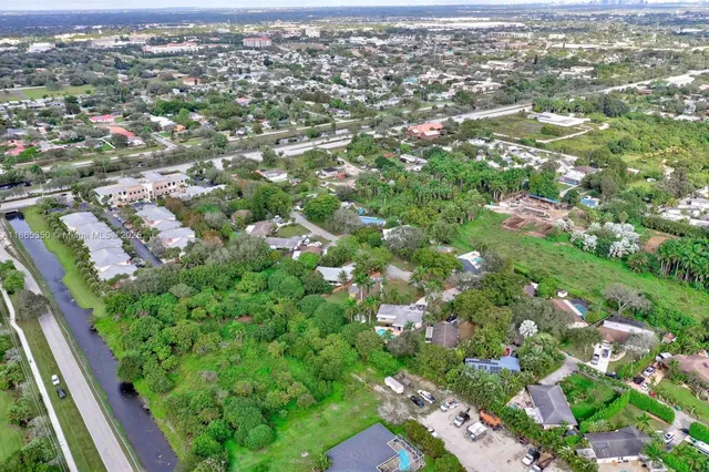 an aerial view of residential houses with city view